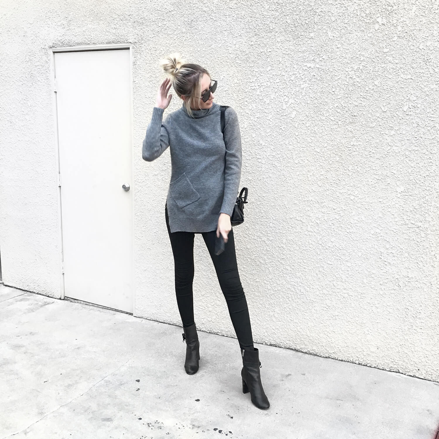 Fall Outfit Ideas Carly Cristman wearing grey Elliatt sweater and black skinny Joes Jeans with ankle boots