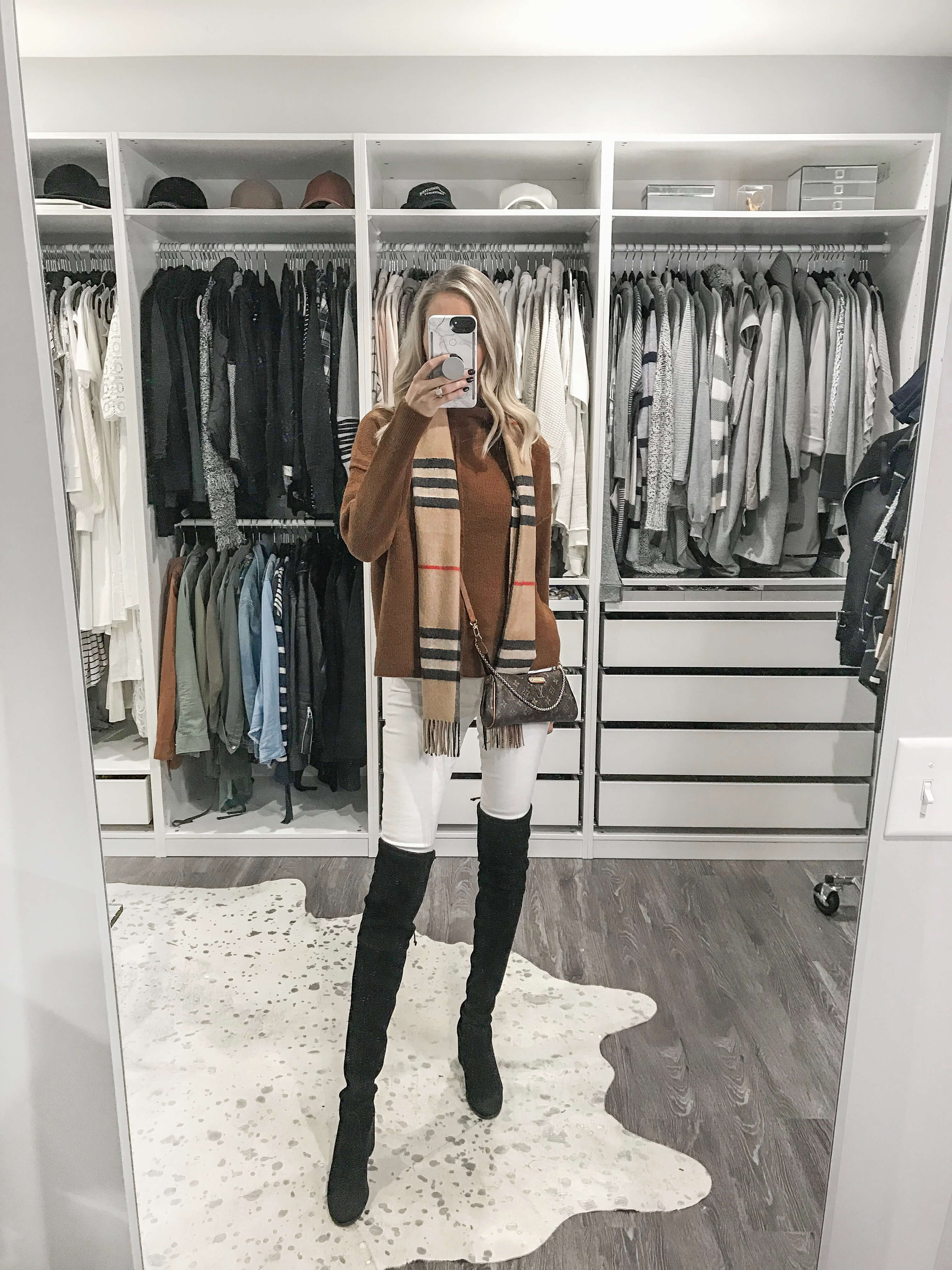 Thanksgiving Outfit Ideas Carly Cristman wearing a brown mock neck sweater with Burberry check scarf Louis Vuitton LV Eva Clutch with Stuart Weitzman Tieland over the knee boots